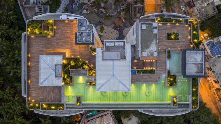 The Vimaana Pool Bar Deck Lit Up At Twilight - Svasa Homes